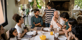 A family having a conversation at a dinner table.