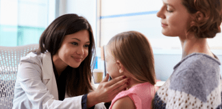 The Moment We Thought Our Daughter Could Have Cancer A doctor checking a child.