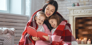 Parenting as Social Justice: My Favorite Books for Babies and Toddlers A mother reading a book to her daughters.