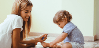 A mom playing with her one year old.