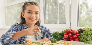 Healthy Children = Healthy Adults A girl eating healthy.