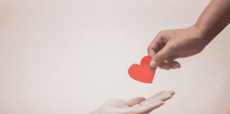This Holiday Season, Teach Your Kids to be Givers handing off a heart