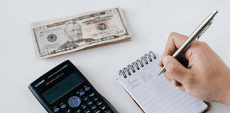 4 Tips to Become a More Financially Aware Mom Taking notes on finances.