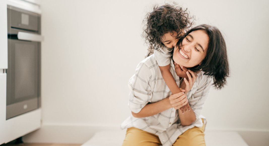 A child hugging a mother.