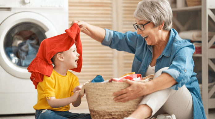 grandma helping a child with the laundry.