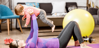 A woman working out with a baby.