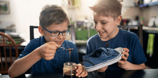 April Fools’ Day Pranks to Play with (and on) Your Kids Kids putting honey into a shoe for an April Fools' trick.