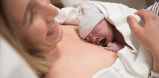 The Best Laid Plans: When Your Birth Plan Goes Out the Window A woman holding a newborn on her chest after birth.