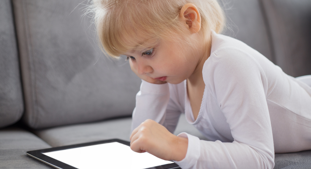 A little girl playing on her iPad.