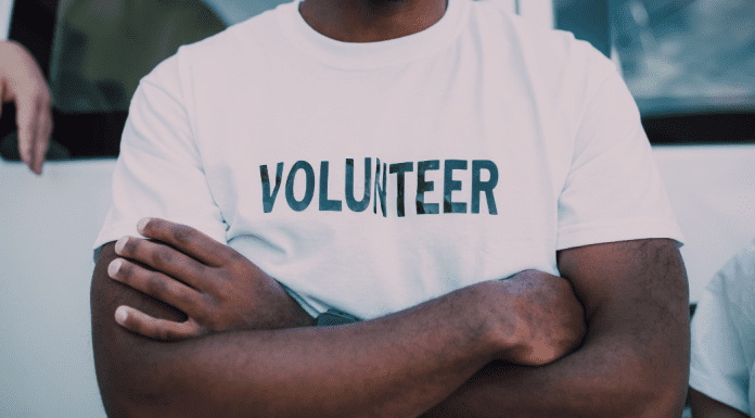 A man wearing a volunteer t-shirt