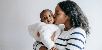To My First Born, On Mother’s Day A mother kissing her baby.