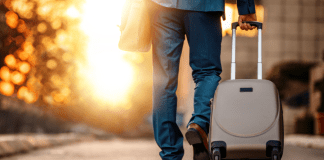 Husband leaving for a business trip with his suitcase.