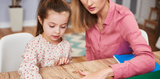 I Am a Special Needs Mom A mother helping her child learn.