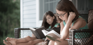The Westchester Mom’s Guide to Summer Reading Girls doing their summer reading outside.
