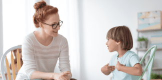 Woman speaking with a young boy.