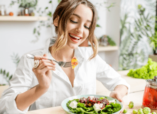 A woman eating a healthy salad.