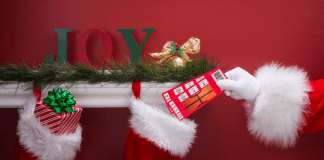 Santa putting basketball tickets into a stocking.