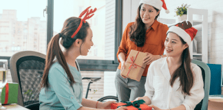 A Guide to Holiday Gifting Parties Women exchanging holiday gifts.