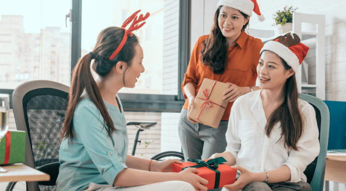 Women exchanging holiday gifts.