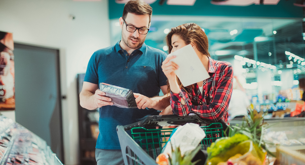 A couple using a list while grocery shopping. 