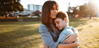 A mother hugging her son.