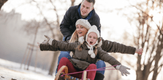 A Mom’s Guide to Westchester County :: December 2017 A family playing outside in the winter.