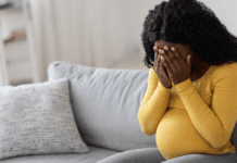 A pregnant woman crying.