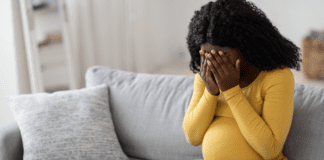 A pregnant woman crying.