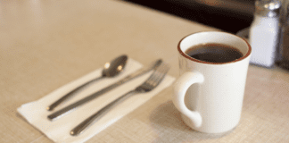 Family Fridays at the Diner A cup of coffee and a table setting at a diner counter.