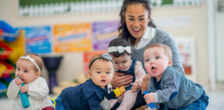 Infants at a daycare center with a teacher.