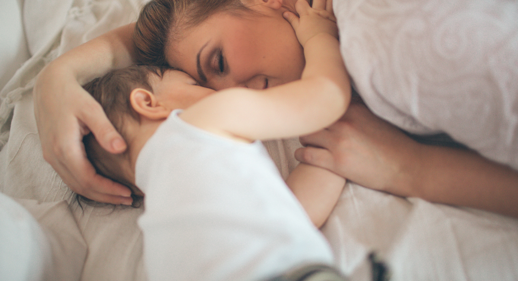 A mom snuggling with her son. 