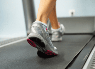 Feet walking on a treadmill.