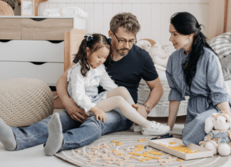 Free Fun A family playing Scrabble on the floor.