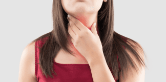 A woman feeling her thyroid.