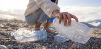 How to Celebrate Random Acts of Kindness Day With Your Kids Picking up trash on the beach.