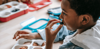 How to Strive for Balance with My Kids’ Meals A kid eating a balanced meal for lunch.