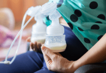 A woman with a breast pump attached.