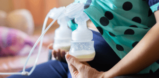 A woman with a breast pump attached.