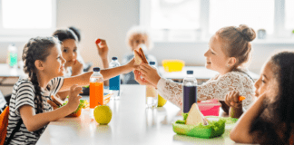 Food Allergies & What They Mean to Your Non-Allergic Child Kids eating and sharing lunch at school.