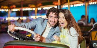A couple riding a bumper car.