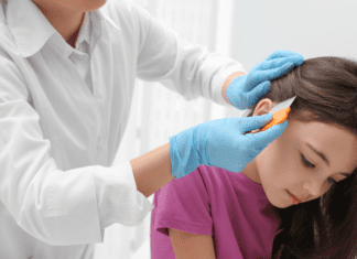 A Lice Free Noggin A girl getting a lice exam.