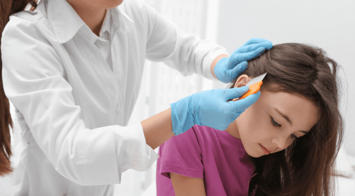 A girl getting a lice exam.