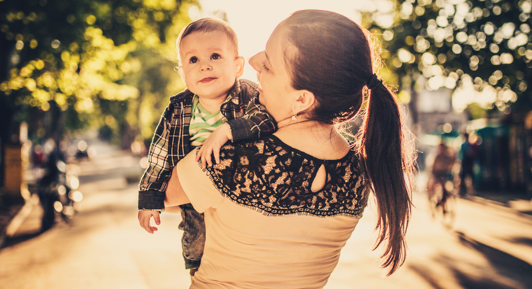 A mom holding her son.