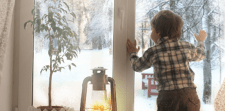 I’m Going to Miss Those Snow Days A boy looking out the window at the falling snow.