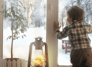 I’m Going to Miss Those Snow Days A boy looking out the window at the falling snow.
