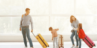 Essential Baby Gear for Traveling A family with their suitcases in the airport.