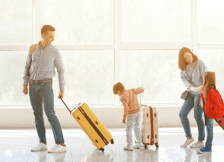 Essential Baby Gear for Traveling A family with their suitcases in the airport.