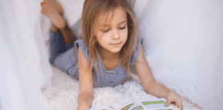 Raising Reluctant Readers A girl reading a graphic novel.