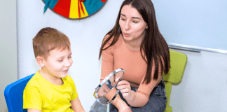 A speech pathologist working with a child.