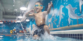 Water Safety Info Every Family Needs to Know A boy jumping into the pool.